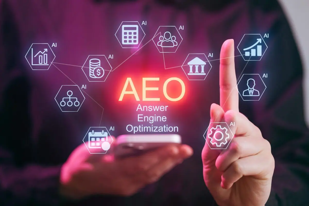 Hand interacting with a glowing holographic display showing AEO for Answer Engine Optimization surrounded by AI-related icons.