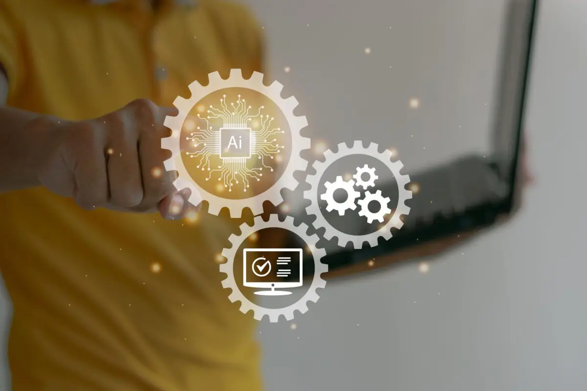 Person interacting with a holographic interface showing AI, gear, and computer icons.