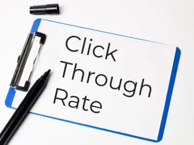 Click Through Rate text written on a clipboard with a black marker nearby.