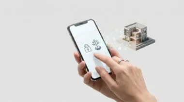 A hand holding a smartphone showing secure investment icons connected to a modern 3D house model.