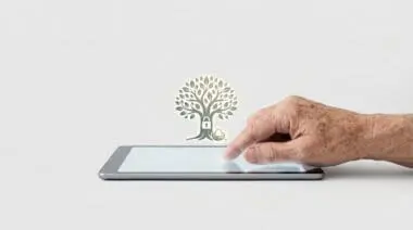 An elderly person's hand interacting with a digital tablet displaying a glowing tree and nest egg icon.