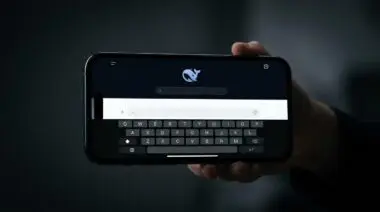 Smartphone displaying DeepSeek app with whale logo and search bar, symbolizing AGI focus over commercial products.