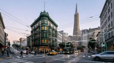 San Francisco intersection with Transamerica Pyramid and green building, glowing data lines overlay representing NVIDIA Cosmos 3 AI training.