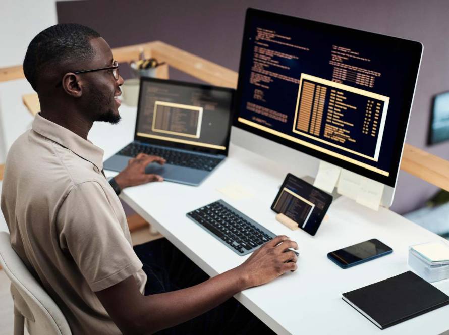 Cheerful software developer examining code - seo web design